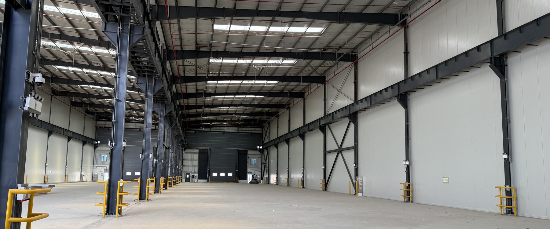 Inside the Steelhaus Abu Dhabi workshop at Metal Park, KEZAD, looking down the length of the hall.